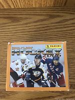 Panini NHL Hockey 2006 orange box featuring three hockey players in full action gear on front.
