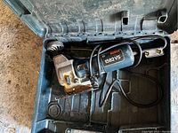 Bosch 1582VS electric jigsaw inside the original carrying case taken from above showing jigsaw and power cord.