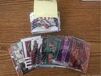 Top view of mixed basketball cards featuring Vince Carter, Pascal Siakam, Kyle Lowry, DeMar DeRozan, Kawhi Leonard with prizm and insert variations on a wooden surface