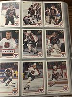 Photo showing nine standard NHL hockey cards in sleeve page featuring various players in NHL action wear with Upper Deck logo.