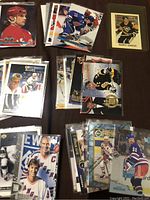 Multiple stacks of NHL hockey cards featuring prominent players in protective sleeves.