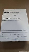 Two boxed sets of Zonkie bike shift cable sets stacked, showing front side with brand and suitability for mountain and road bikes.