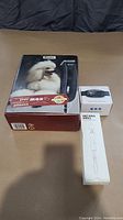 Photo of Wahl Max45 clipper box with poodle image and two other boxes for dog care devices.