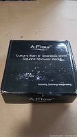 Black box showing the front side with text: 'A-Flow Luxury Rain 8" Stainless Steel Square Shower Head. Relaxing. Soothing. Invigorating.'