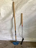 Full view of the garden edger and grass shear on a white background, showing size and overall condition.