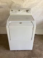 Front view of white Maytag Atlantis electric dryer showing full unit with front door closed.