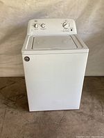 Front view of the white Roper top-load washing machine showing overall condition and lid.