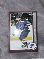Front of hockey card showing Al MacInnis in St. Louis Blues uniform, with team logo and player name.