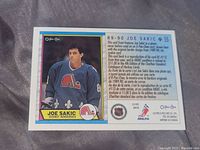 Back of 1990-91 O-Pee-Chee Joe Sakic rookie card showing player info and reproduction statement