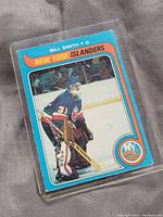 Front of 1979 Bill Smith hockey card showing player in goalie gear and team logo.