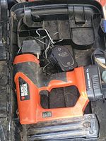 Black & Decker 12 Volt air nailer with battery pack and charger inside the carrying case.