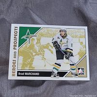 Front of Brad Marchand Heroes and Prospects hockey card, showing full action image and card title.