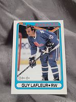 Front of the hockey card showing Guy Lafleur in Quebec Nordiques uniform with card branding and player info.