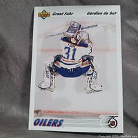 Front of hockey card showing Grant Fuhr as Oilers goalie in uniform number 31, crouched in goaltending stance.