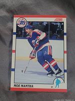 Front side of Moe Mantha hockey card showing full action image in Winnipeg Jets uniform.