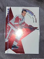 Front view of Nicklas Lidstrom hockey card with red star background and International All-Star First Team Defense text.