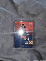 Front side of the Olli Jokinen hockey card in protective plastic sleeve, showing player in Florida Panthers uniform, with red and blue background and team logo.