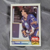 Front view of 1989-90 Topps Pierre Turgeon hockey card showing player image and team scoring leaders graphic.