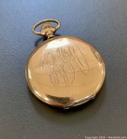 Closed view of engraved monogram on gold filled pocket watch case