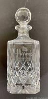 Photo of the heavy cut crystal scotch whisky decanter etched with Harrods logo and 21 Years Old Scotch Whisky text, stopper on top, showing diamond cut pattern detail.