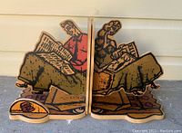 Pair of vintage wooden bookends each shaped and hand-painted as a seated figure reading; man and woman facing each other