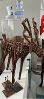 Wicker reindeer decoration with metal base platforms visible, showing rustic style and dimensions.