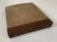 Closed textured fabric and leather folio with decorative music notes on spine