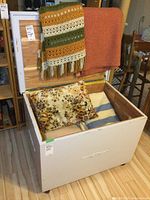 Blanket box open showing interior with cedar lining and blankets inside