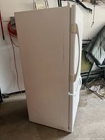 Exterior side view of white refrigerator unit