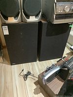 Two rectangular Panasonic Thrusters speakers with black mesh front covers and visible Panasonic logo on one speaker.