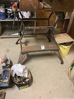 Front view of the Black And Decker Workmate work bench showing the wooden top, metal frame, and overall structure in worn condition.