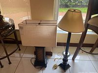 Two table lamps side by side, showing rectangular shade and wooden bases.