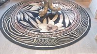 Round floral design area rug on floor