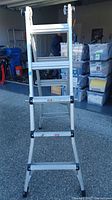 Front view of ladder in extension mode showing aluminum construction and multiple rungs.