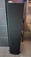Front view of one black floor-standing speaker with cloth grille and Klipsch logo