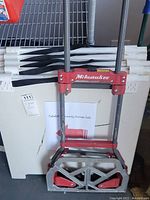Front view of Milwaukee adjustable hand truck showing foldable frame and handle with brand label.