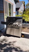 Front-right view of entire grill showing lid, control panel and cabinet