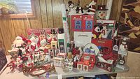 Full overview of tabletop filled with assorted Christmas decorations