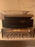Front view of Pioneer turntable on top of Sansui cassette deck and Pioneer receiver