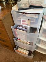 Four-drawer translucent plastic storage cart filled with embroidery design kits
