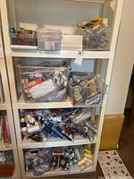 Full shelf unit with multiple bins of thread spools and sewing notions
