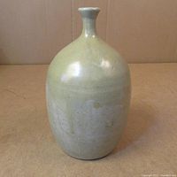 Full view of the bud vase showing the glazed body and shape