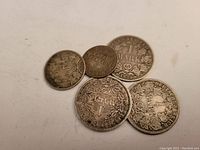 Five assorted German silver coins showing obverse side with denomination and date details.