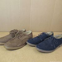 Pair of brown and navy blue men's size 10 suede dress shoes displayed side-by-side showing profile view