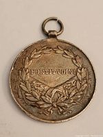 Front side of the silver medal showing 'FORTITVDINI' inscription within a laurel wreath