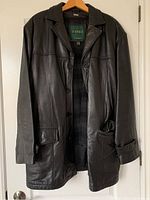 Front view of men's black Danier Canada leather jacket showing buttons, collar, and pockets.