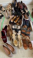 Overview of assorted women's shoes on carpet