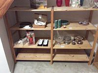 Photo of the wooden shelving unit with various small decorative items placed on the shelves, showing the structure and condition.