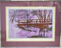 Framed silkscreen print 'The Bridge' with vibrant colors, visible portion of double matting and silver frame.
