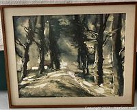Framed lithograph print showing a winter forest landscape with snow and dark trees, under glass with beige matting.